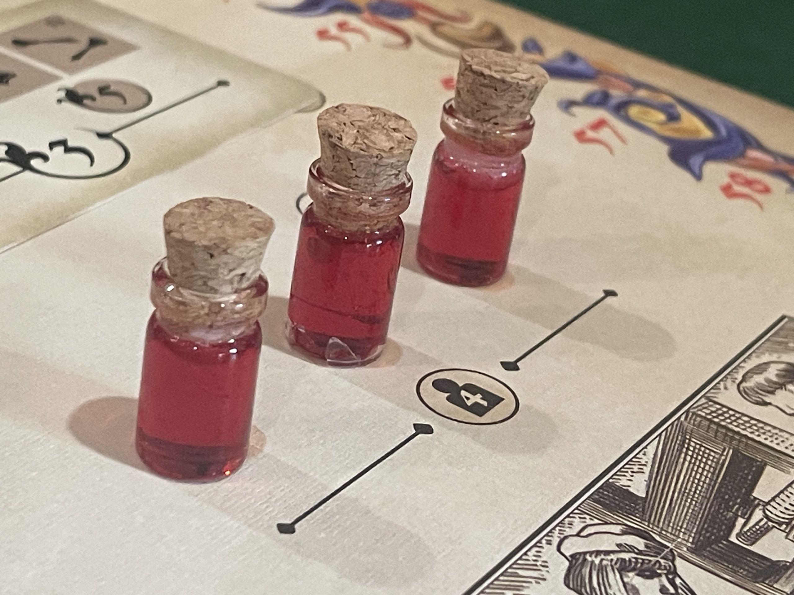 Red ink vials on a game board.